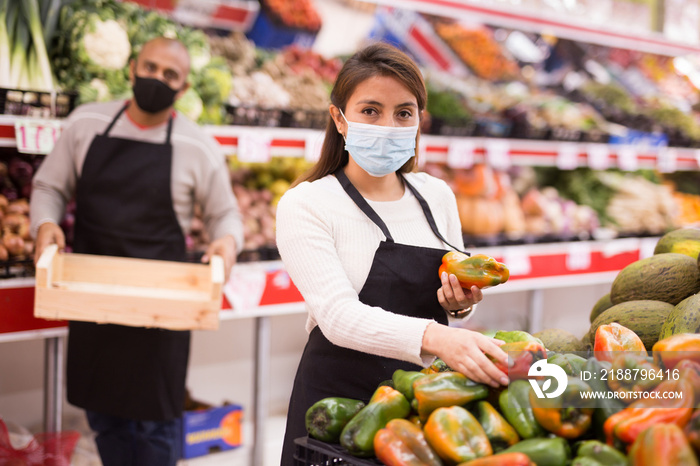 Latin supermarket workers in personal protective equipment during coronavirus quarantine