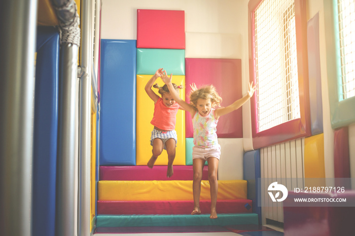 Two little girls in playground. Caucasian girls playing together.