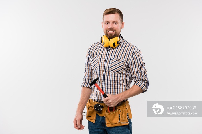 Bearded smiling technician with protective earphones