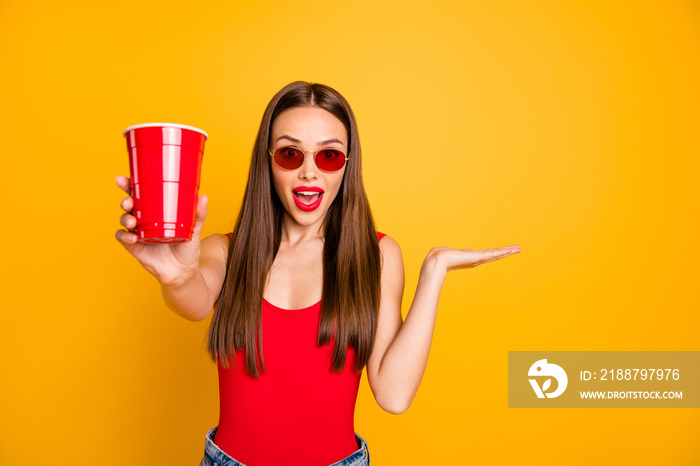 Close up photo of beautiful lady bright lips hold hand alcohol beverage shocked good taste wear sun specs red body tank-top denim shorts