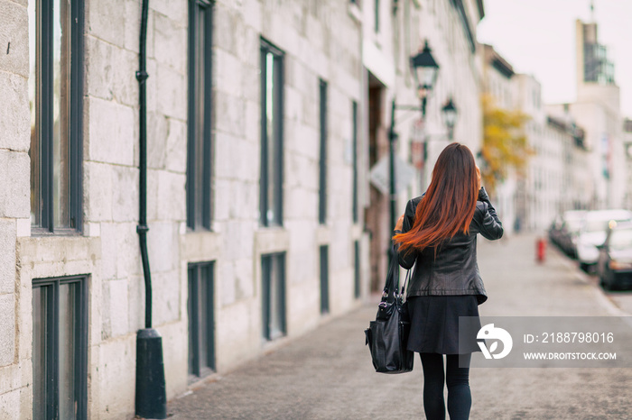 Ombre hair coloring woman walking with colered end of hair with lighter brown tone. Urban city lifestyle young people with dyed hairstyle.