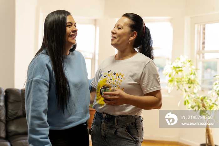 Two women standing in living room