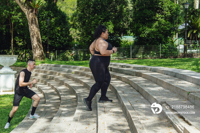 Two friends going on a run together in the park