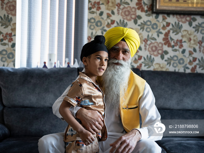 Portrait of grandfather and grandson (6-7) in traditional clothing