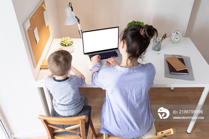 Home work concept. Working from home during the coronavirus pandemic COVID-19. Mother telecommuting while her child playing