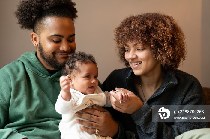 Parents with baby daughter at home