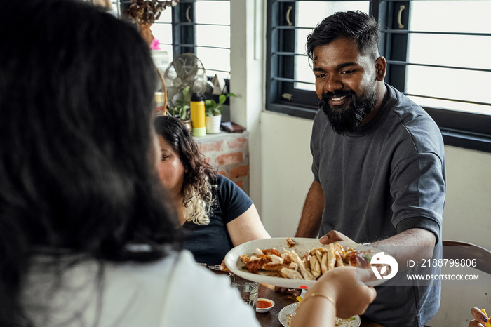 Group of friends sharing a meal together at home