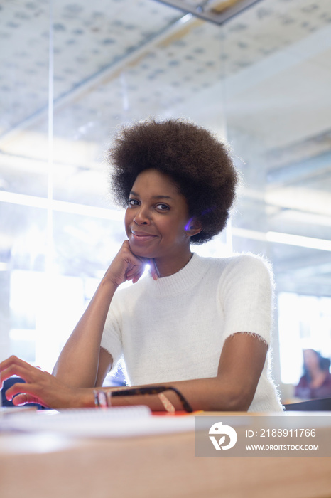 Portrait confident young businesswoman with afro in office