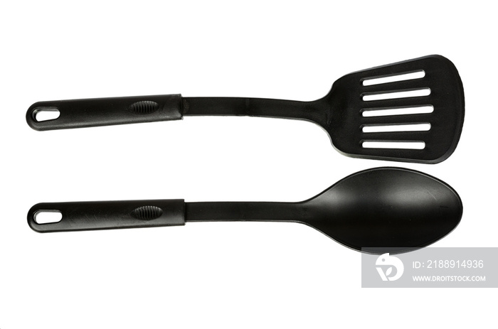 Hand with Black plastic kitchen spoon and spatula, kitchenware for cooking