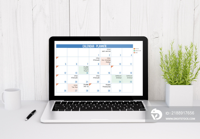 laptop on table calendar