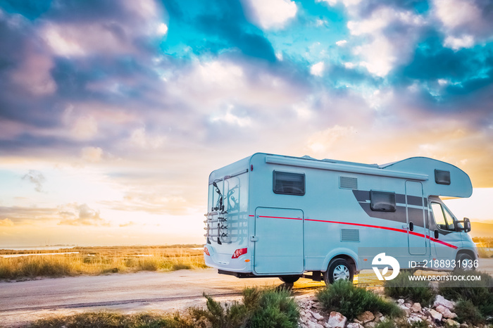 Travel to see beautiful sunsets by motorhome on holidays on rural roads.