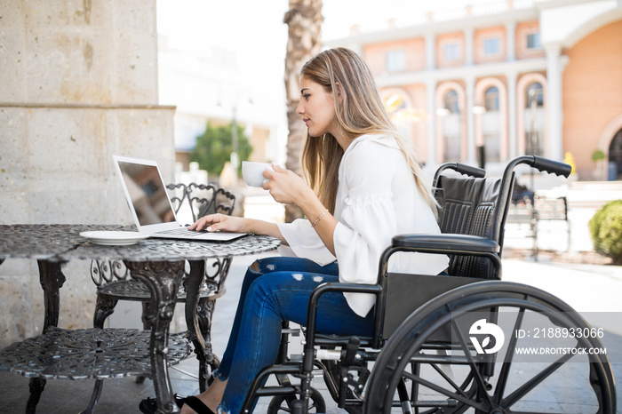 Disabled woman working and enjoying coffee