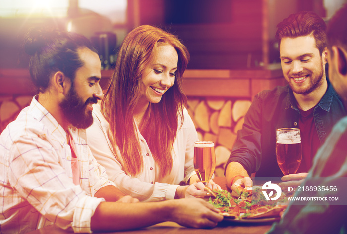 friends sharing pizza with beer at pizzeria