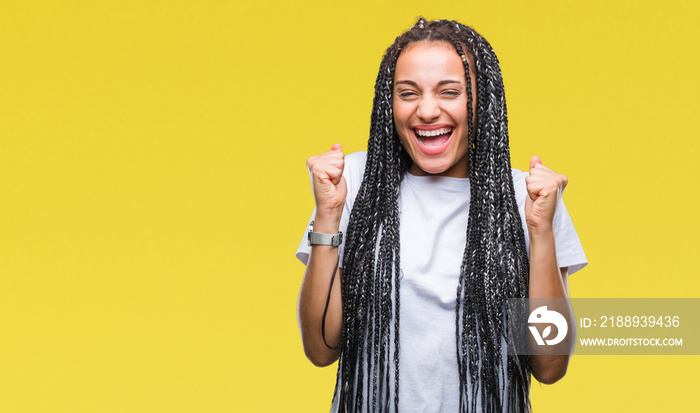 Young braided hair african american girl over isolated background excited for success with arms rais