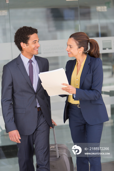 Business people with suitcase talking in office