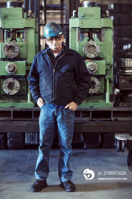 Portrait of senior man standing in factory