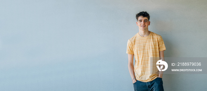 casual teenager portrait isolated on wall background