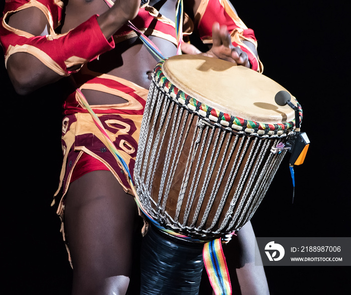 Detail of african drummer beating the drum