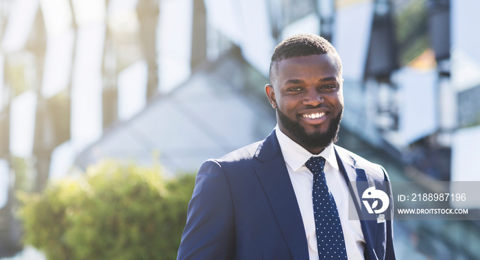 Businessman Smiling Looking At Camera Standing In Modern Urban Area