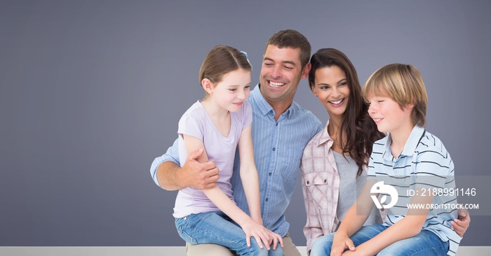 Family sitting together with purple background