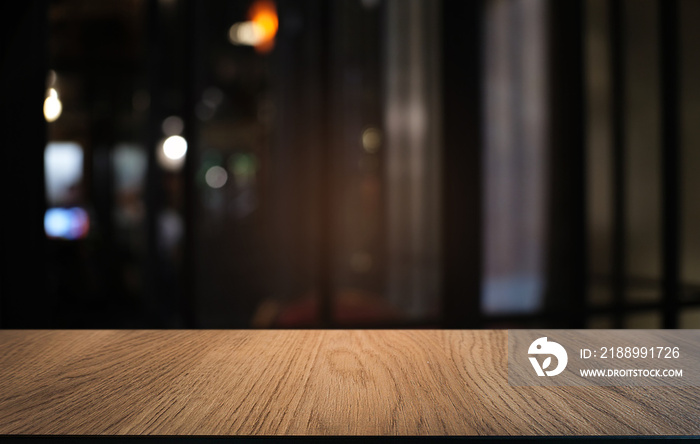 Empty dark wooden table in front of abstract blurred bokeh background of restaurant . can be used fo