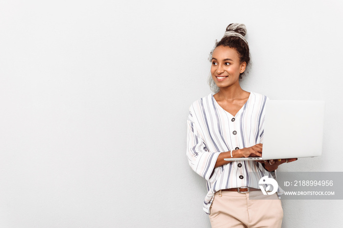 Happy positive young african business woman with dreads isolated over white wall background using la