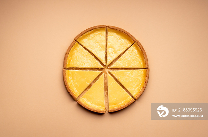 Sliced cheesecake on a yellow background. Equal sliced cake