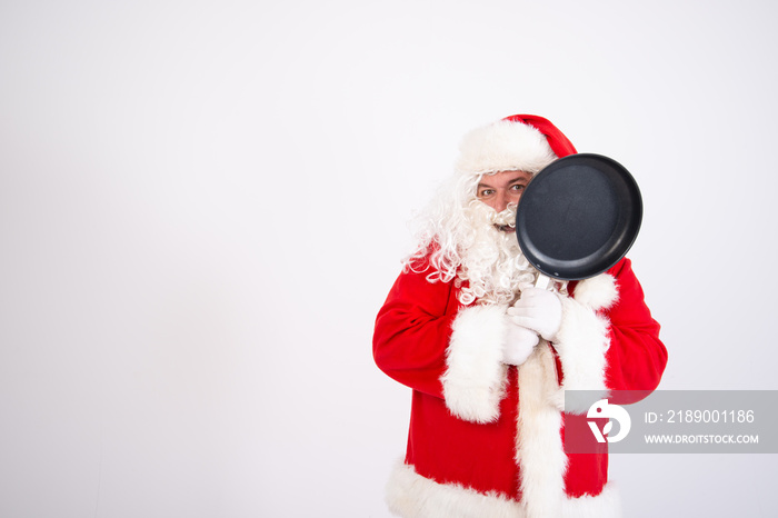 Funny Santa Claus with a frying pan.