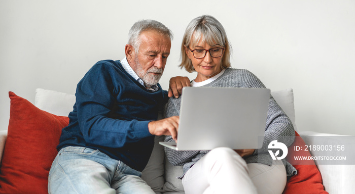 Senior couple family having good time using laptop computer together.Happy elderly husband and wife 