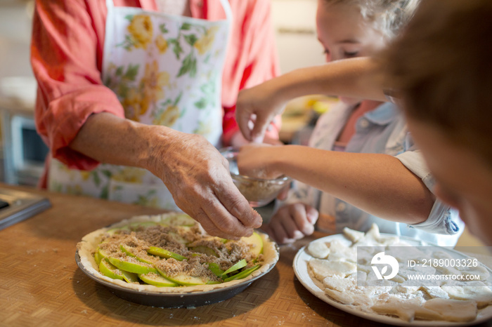 Children (6-7) cooking with grandmother