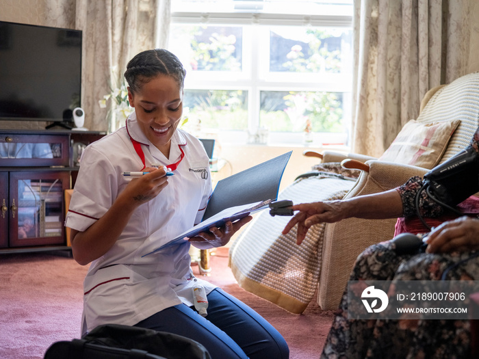 Nurse�taking care of elderly woman, measuring oxygen saturation