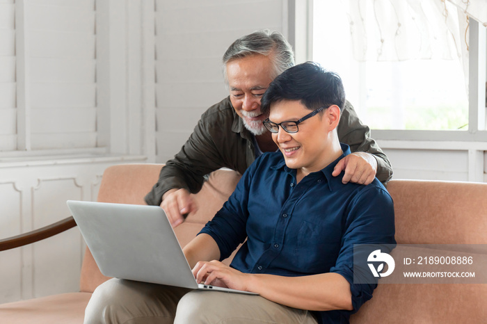 Cheerful asian middle aged son and senior father in living room, Happiness Asian family concepts