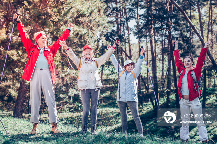 Retired people and their group leader feeling happy after hiking