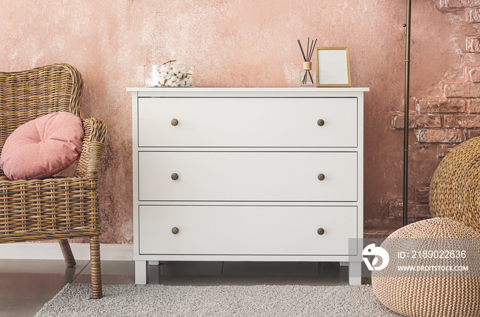 Interior of stylish living room with modern chest of drawers