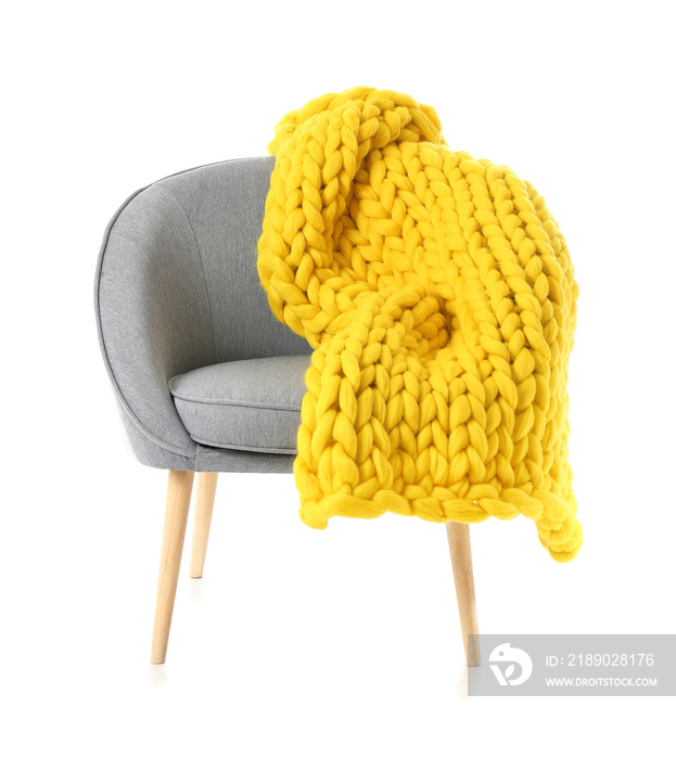 Armchair with knitted plaid on white background