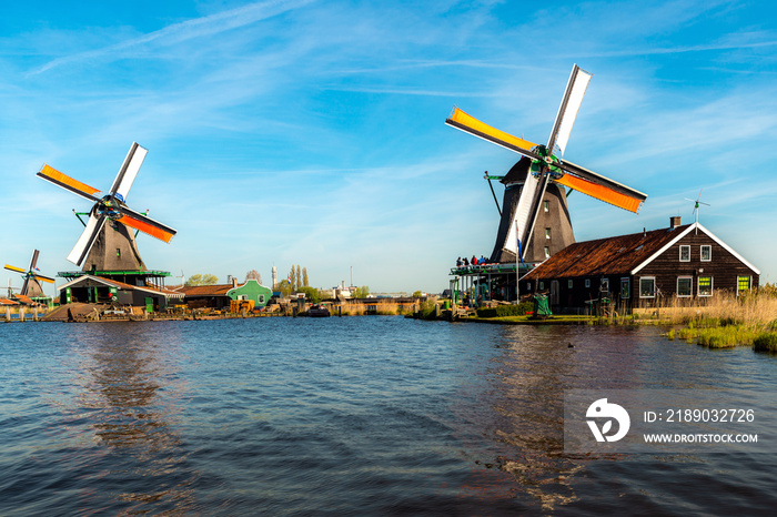 Traditional dutch windmills located by the river Zaan, in Zaanse Schans, Netherlands.