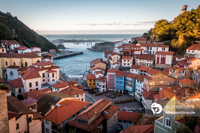 Landscape of Cudillero surrounded by hills and sea under the sunlight in Spain