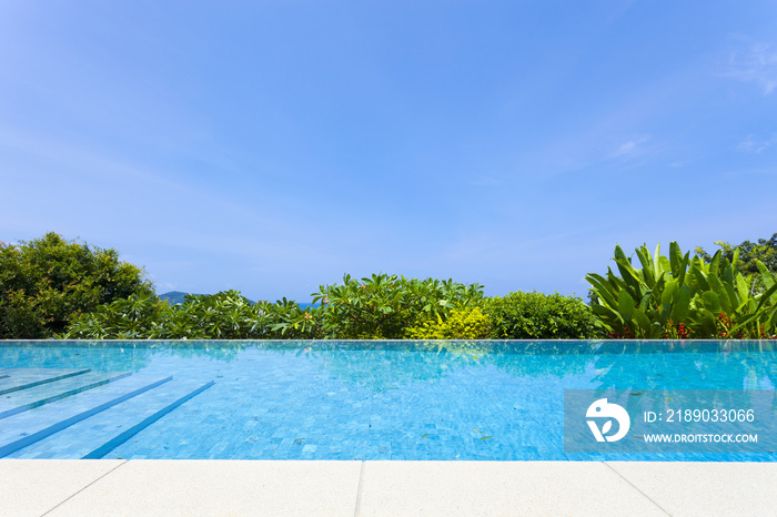 Swimming pool overlooking view andaman sea mountains and blue sky background,summer holiday backgrou