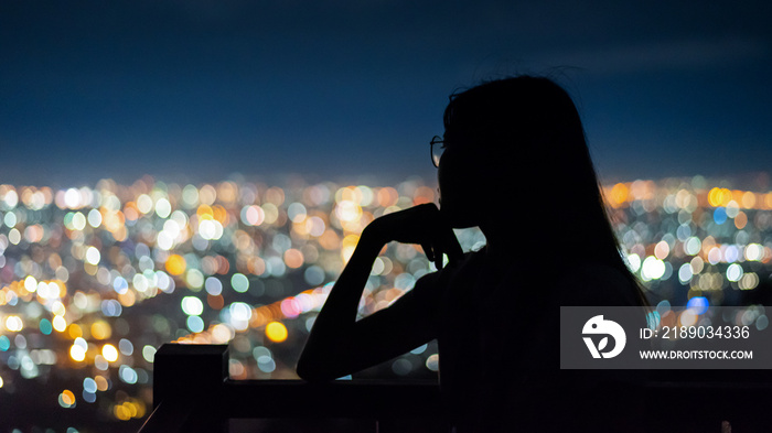 silhouette Woman portrait  in city night light bokeh background , Chiang mai ,Thailand