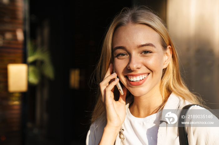 Close up portrait smiling young woman walking