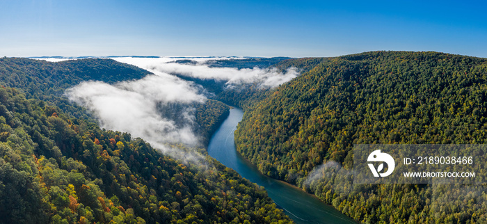 Aerial drone image of the Cheat River flowing through narrow wooded gorge in the autumn towards Chea