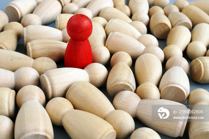 Successful leader in the business. Red wooden figurine. Competitive edge.