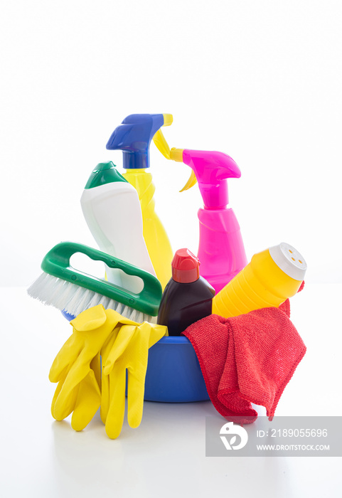 Cleaning supplies in a blue bowl isolated against white background.
