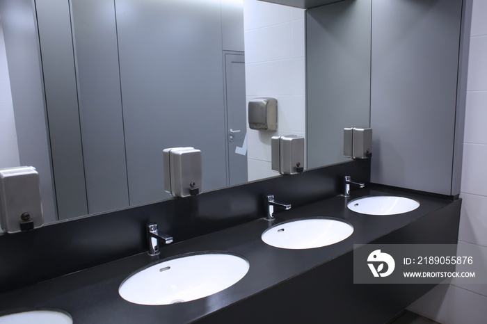 Modern sinks with mirror in public toilet