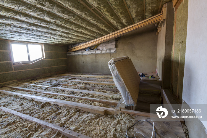 House attic under construction. Mansard walls and ceiling insulation with rock wool. Fiberglass insu