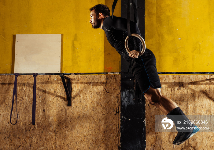 Muscle ups rings man swinging workout exercise at gym