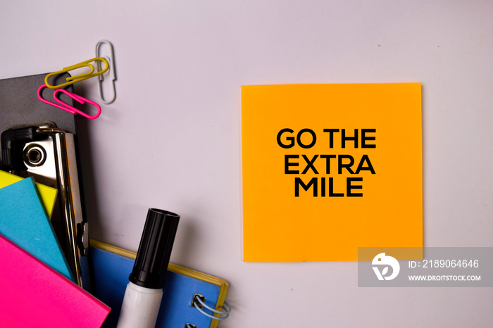 Go The Extra Mile on sticky notes isolated on white background.