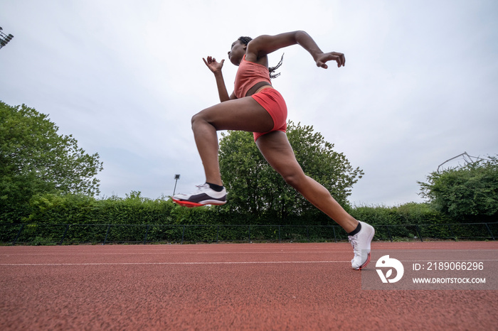 Low angle view of athletic�woman running on track