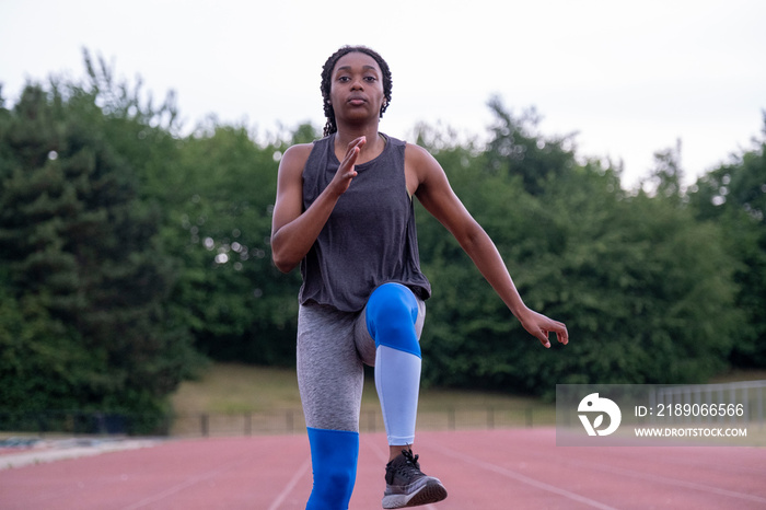 Athletic�woman running on track