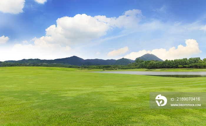 Golf course with Green grass and trees in beautiful park under the blue sky